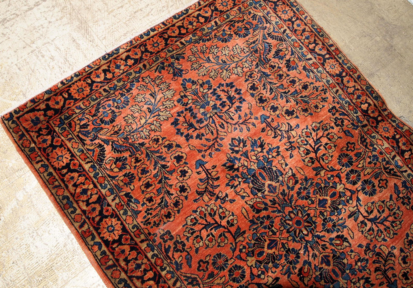 Antique Sarouk rug in red shade with classic floral design. The rug is from the beginning of 20th century in original good condition.