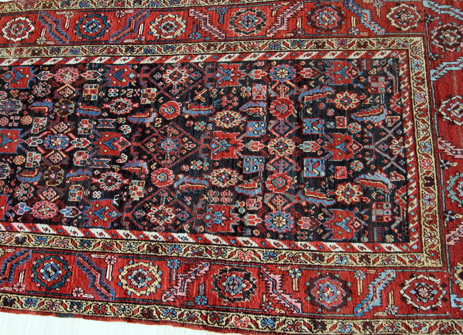 Handmade antique Bakhsaish runner in chocolate brown, red and blue shades. It is from the end of 19th century in good condition.