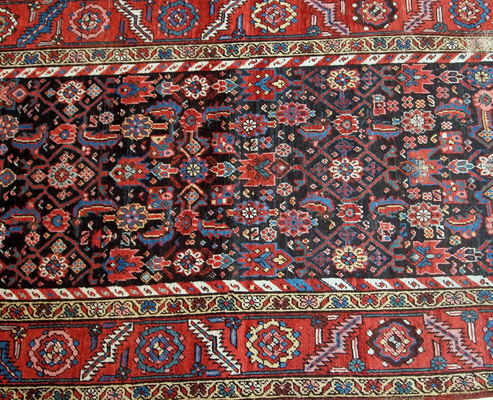 Handmade antique Bakhsaish runner in chocolate brown, red and blue shades. It is from the end of 19th century in good condition.
