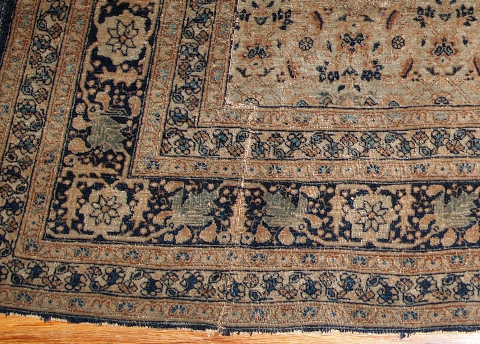 Antique Persian Tabriz Hajalili rug in beige, brown and blue wool. The rug is from the end of 19th century, it has one cut.
