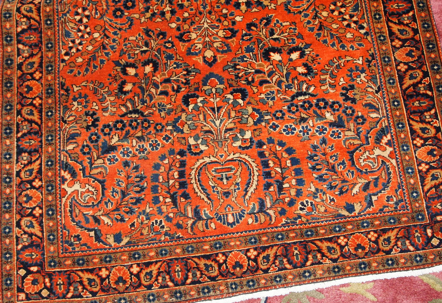 Hand made antique Persian Sarouk rug in red wool. The rug is in original good condition from the beginning of 20th century.