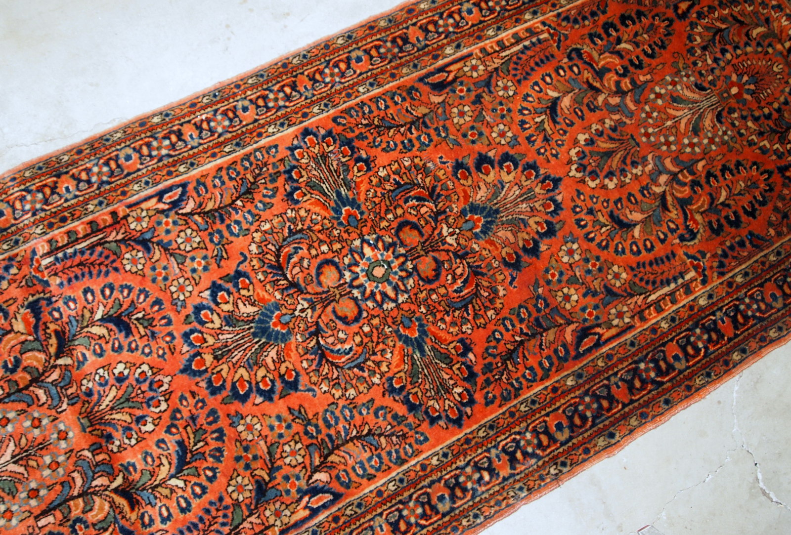 Antique Persian Sarouk rug in original good condition. The rug is from the beginning of 20th century, made in red wool.