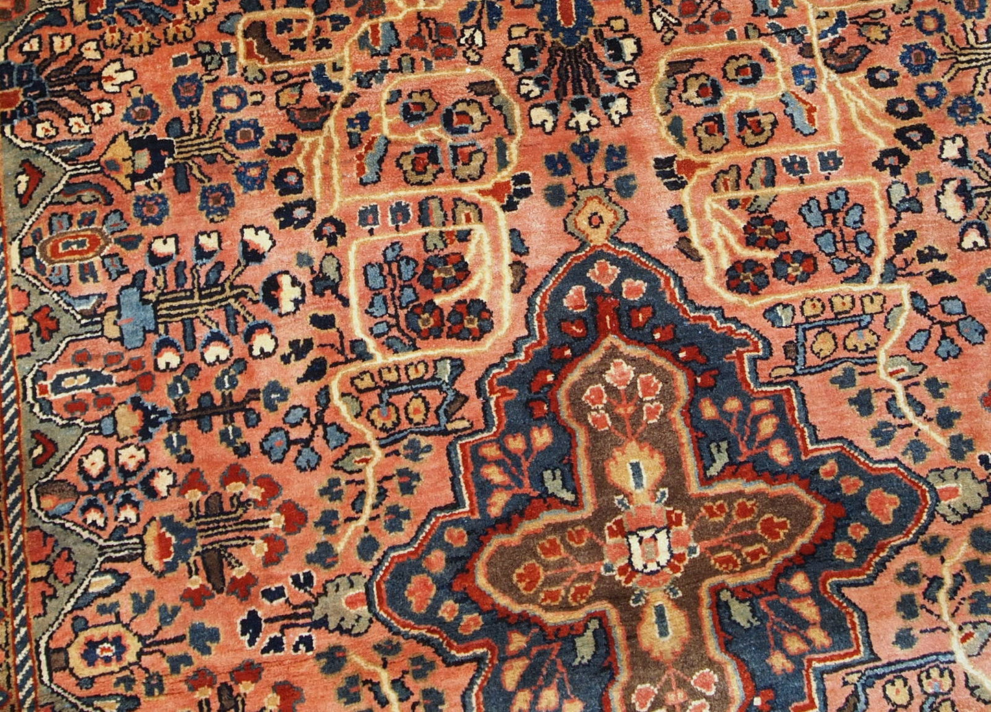 Antique hand made Persian Sarouk rug in peach shades. The rug is from the beginning of 20th century in original good condition.