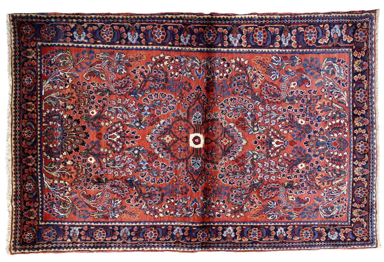 Antique handmade Persian Sarouk rug in red color. The rug is in original good condition from the beginning of 20th century.