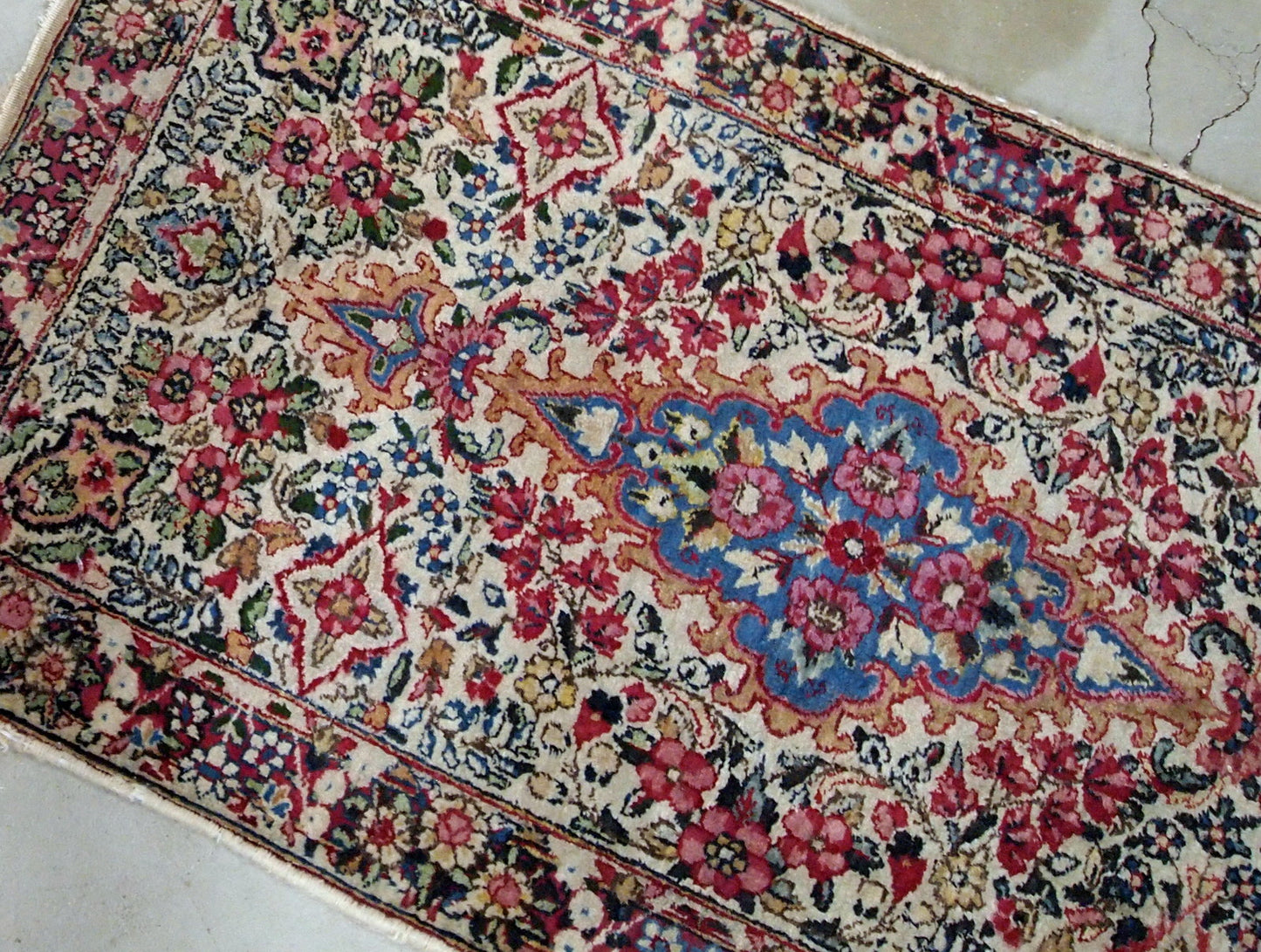 Antique handmade Persian Kerman rug in colorful shades. It is from the beginning of 20th century in original good condition.