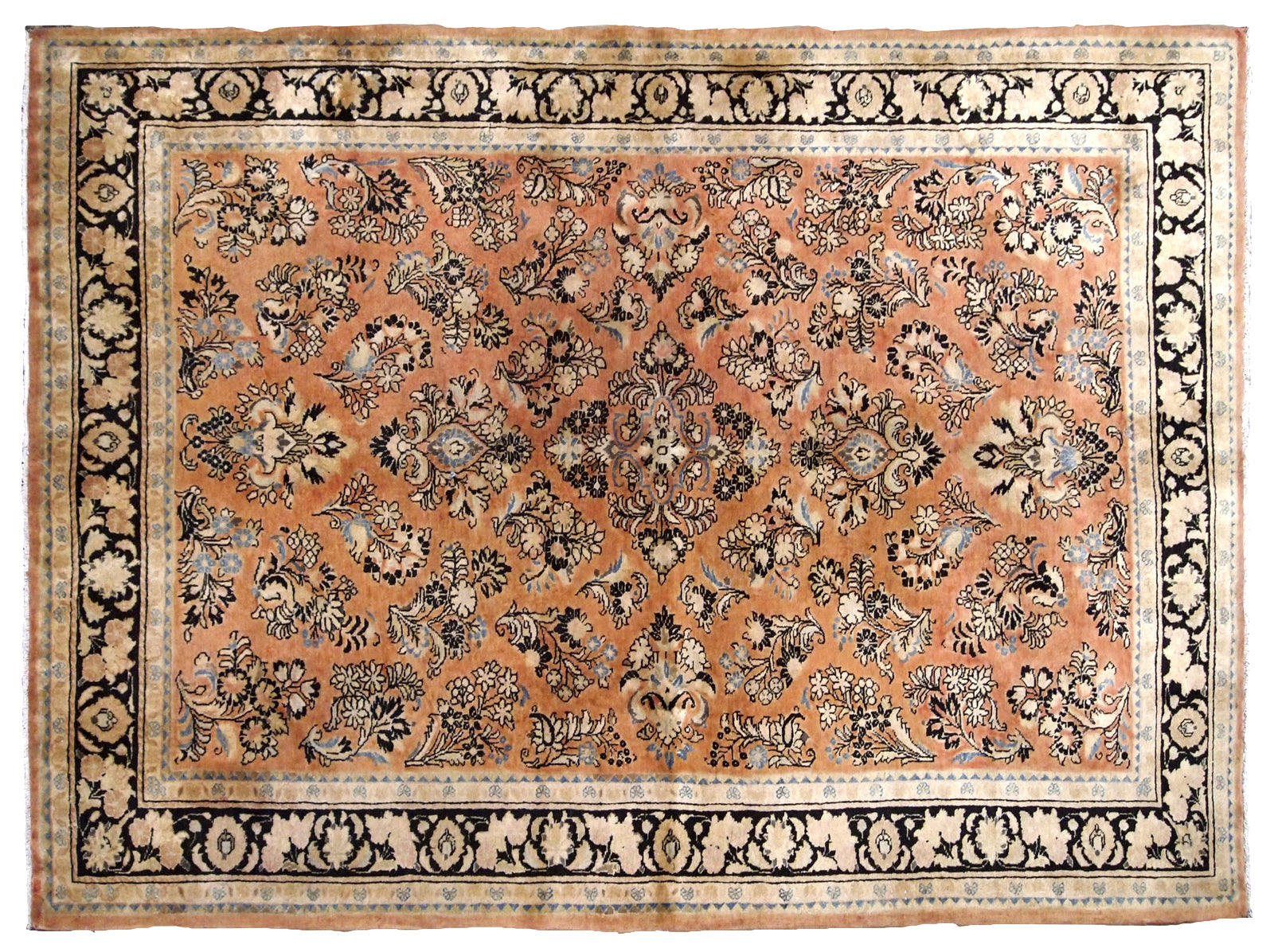 Antique hand made Persian Sarouk rug in salmon shade. The rug is from the beginning of 20th century in original good condition.