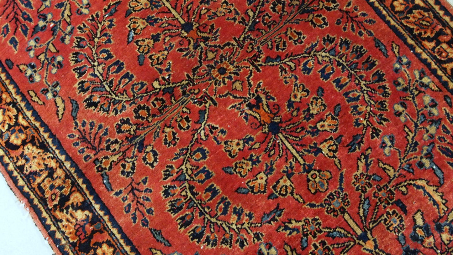 Antique hand made Persian Sarouk runner in red wool and floral design. The rug made in 1900s and it is in original good condition.