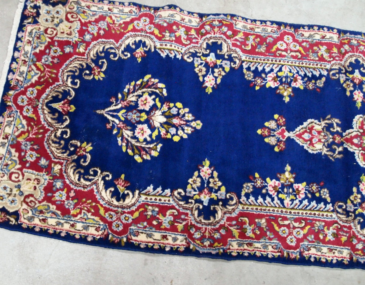 Handmade antique Persian Kerman runner in bright blue and red wool. The runner is from the middle of 20th century in original good condition.