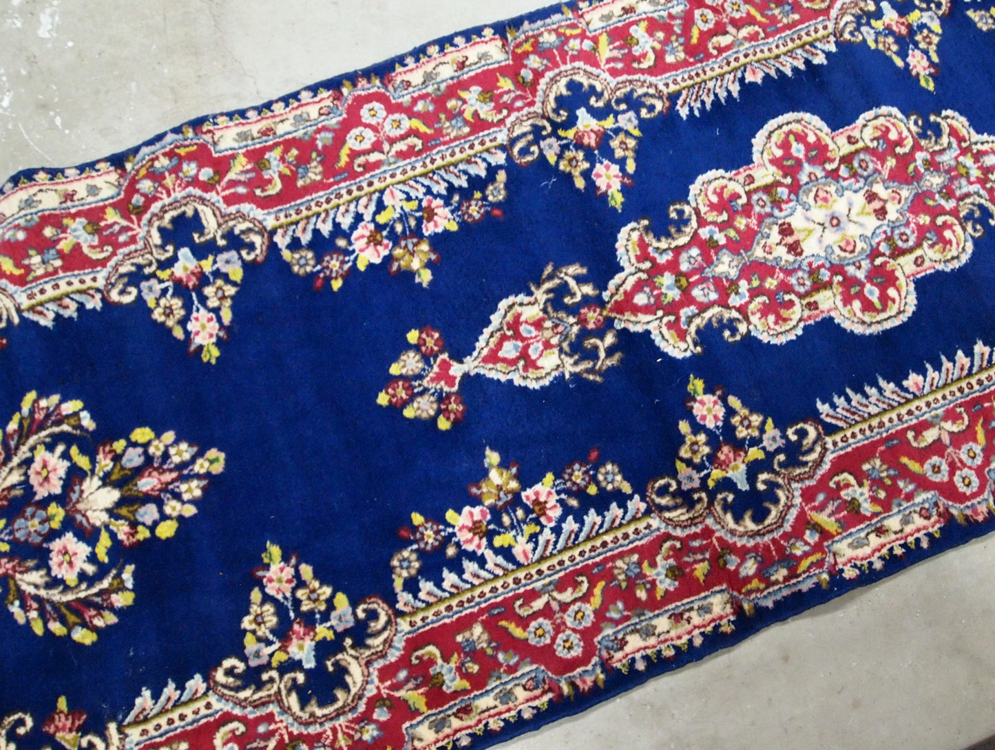 Handmade antique Persian Kerman runner in bright blue and red wool. The runner is from the middle of 20th century in original good condition.