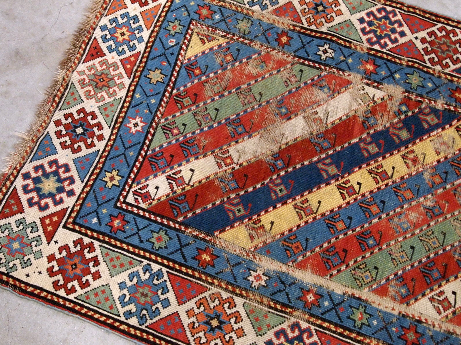 Handmade antique Caucasian rug in distressed condition, from the end of 19th century. 