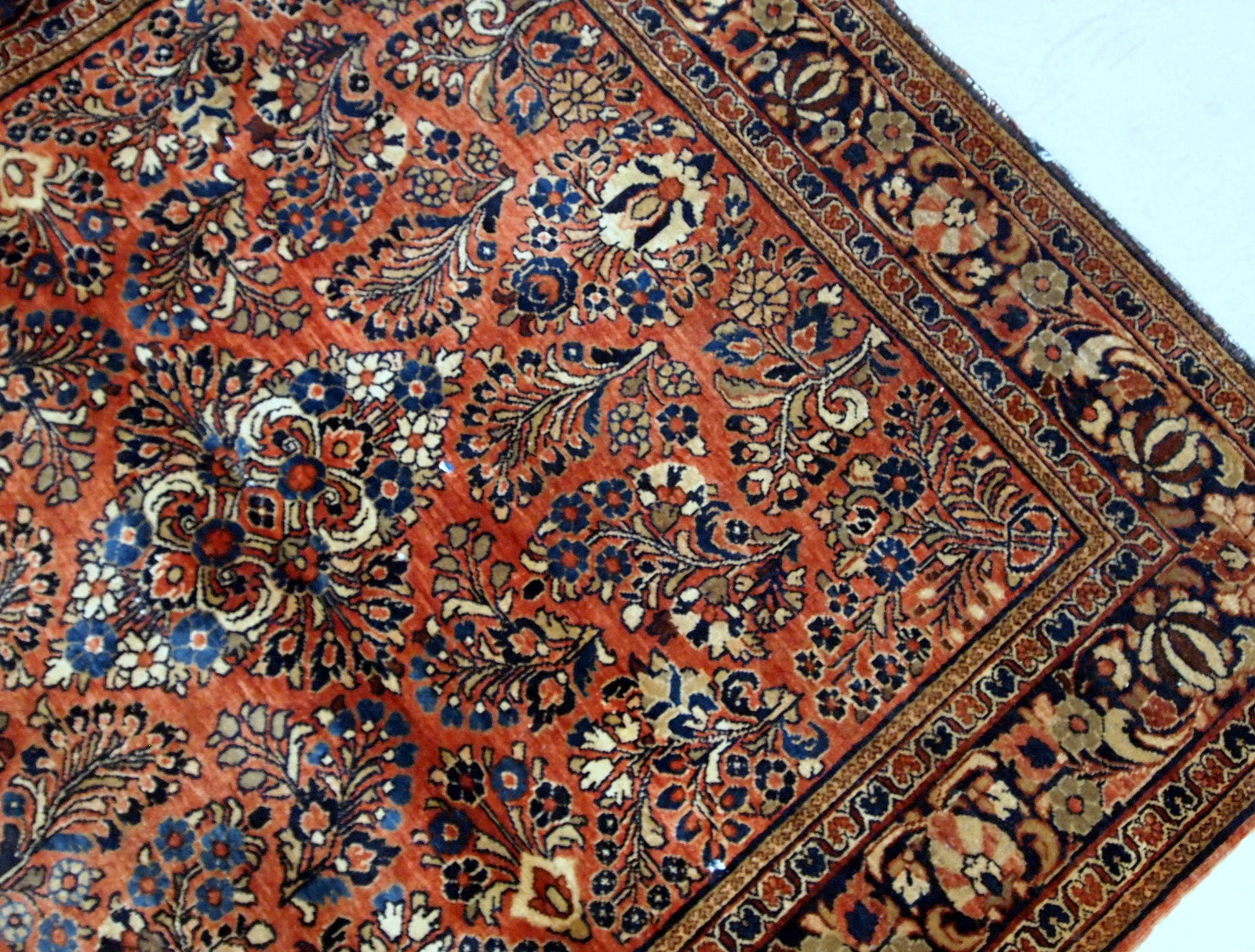Antique hand-woven Sarouk rug in traditional design and red color. It has been made in the beginning of 20th century and in original good condition.