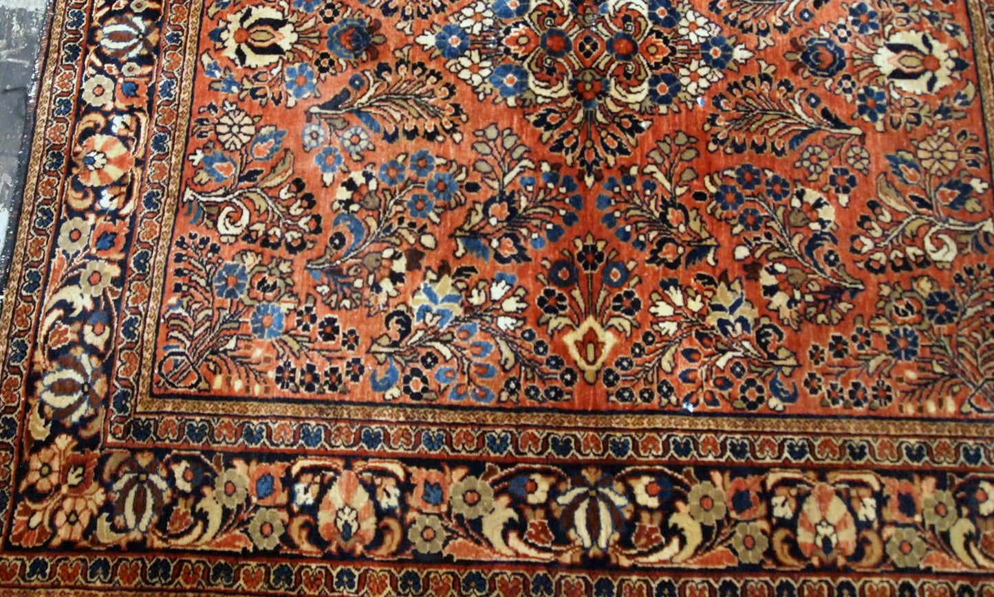 Antique hand-woven Sarouk rug in traditional design and red color. It has been made in the beginning of 20th century and in original good condition.