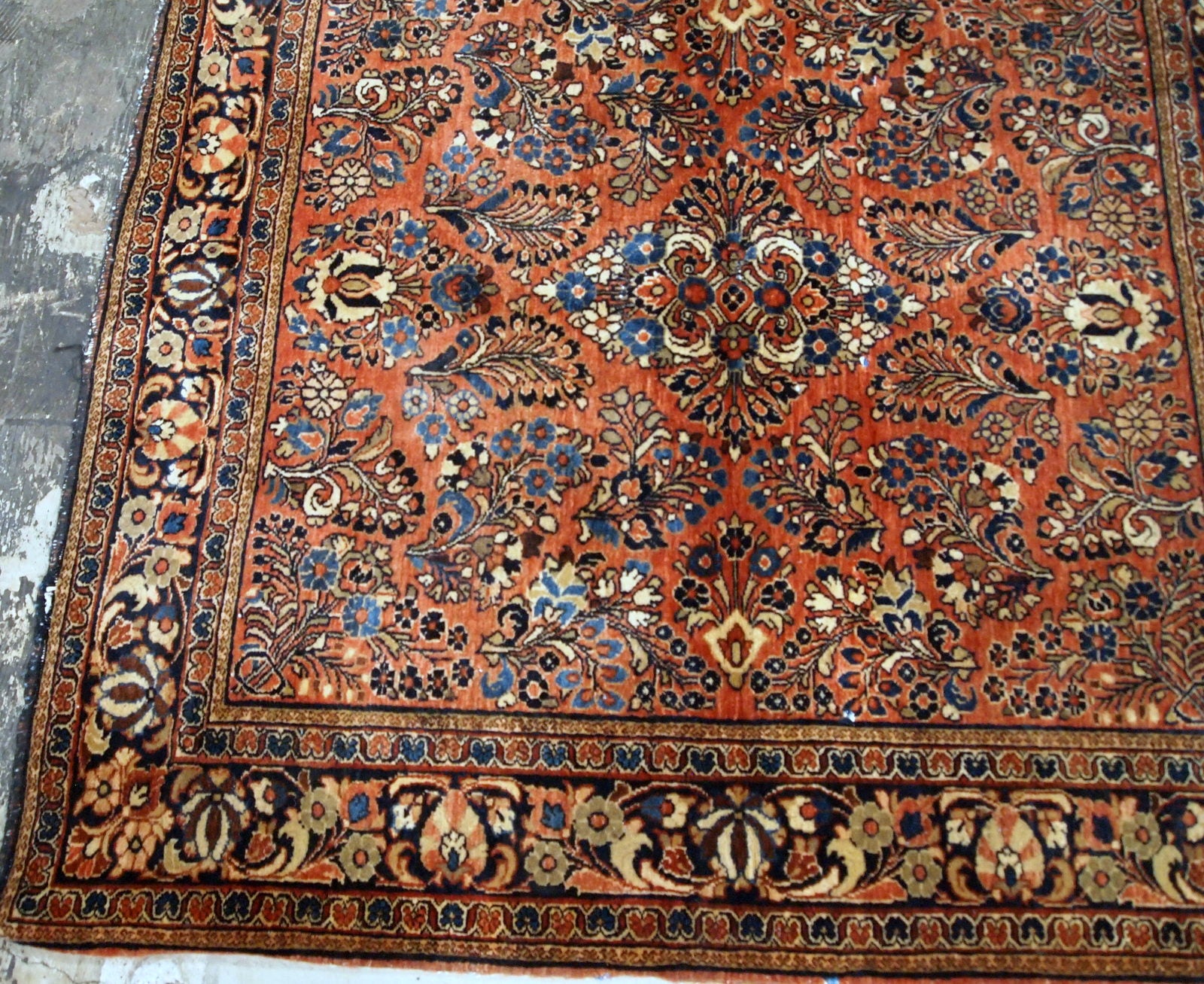 Antique hand-woven Sarouk rug in traditional design and red color. It has been made in the beginning of 20th century and in original good condition.