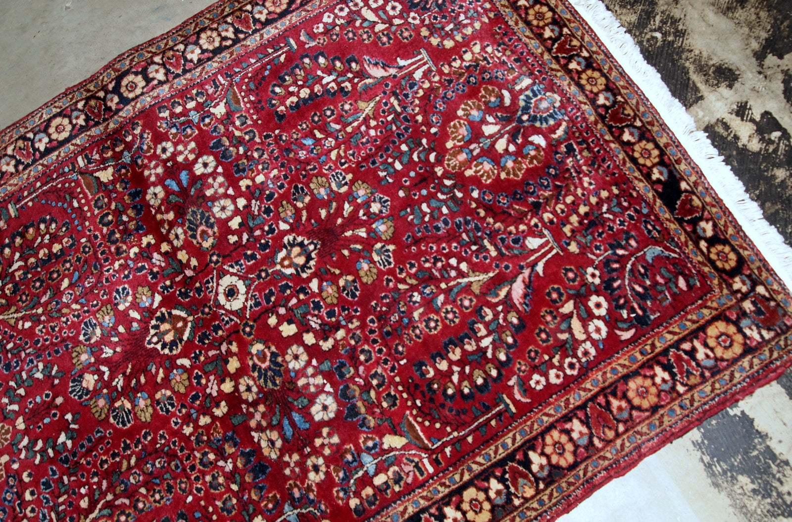 Handmade antique Sarouk rug in bright red colour. The rug is in original good condition from the beginning of 20th century.