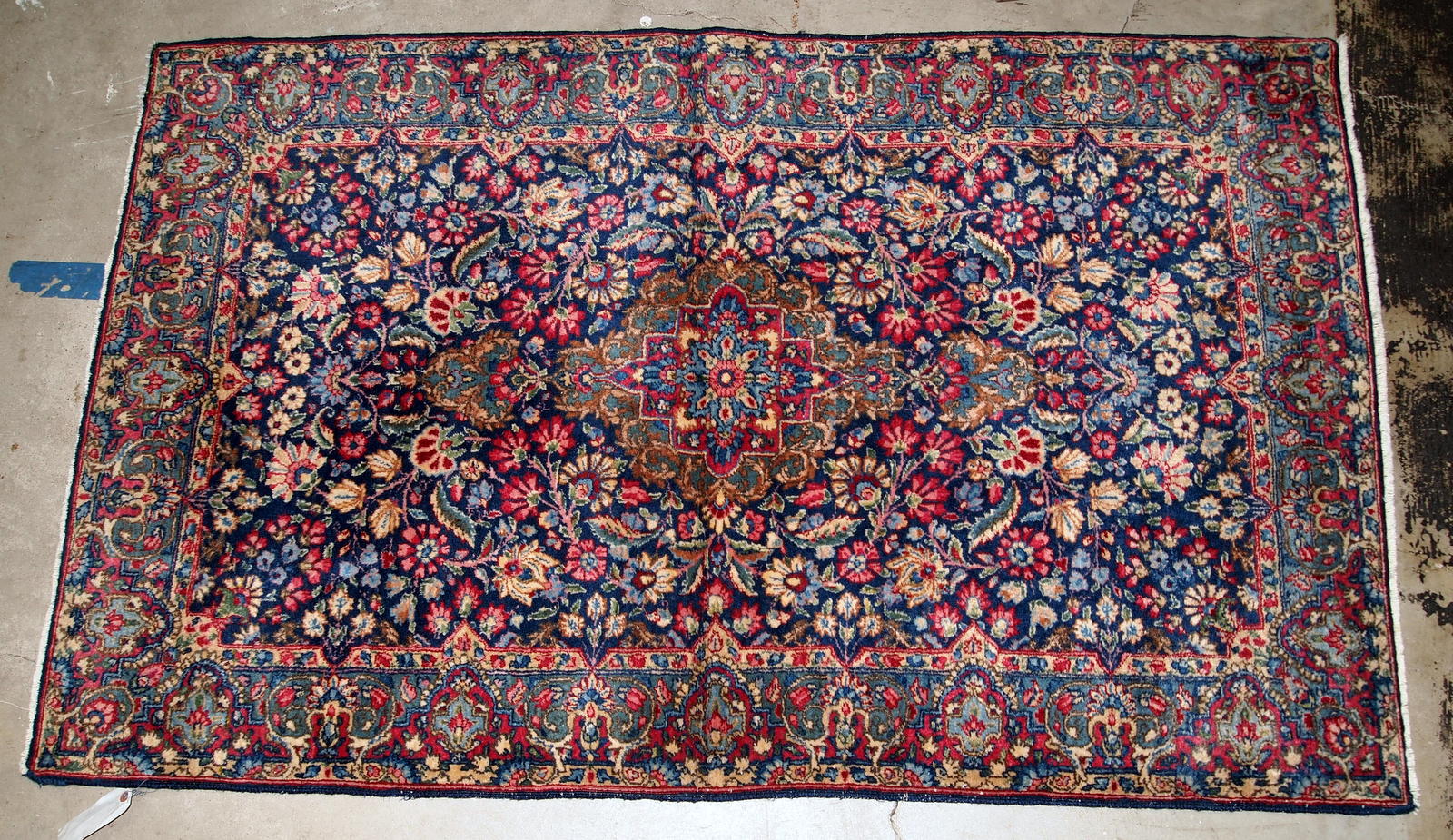 Handmade antique Kerman rug from the beginning of 20th century. The rug is in original good condition made in colorful shades and floral design.