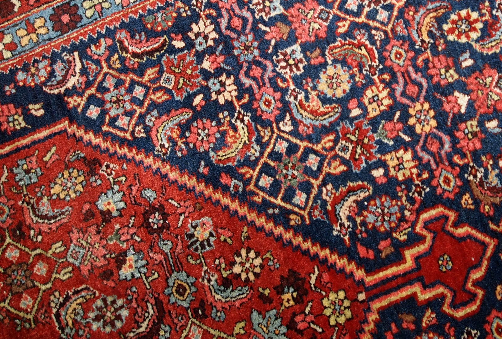 Handmade antique Bidjar rug from the beginning of 20th century. The rug is in original good condition made in red and blue wool.