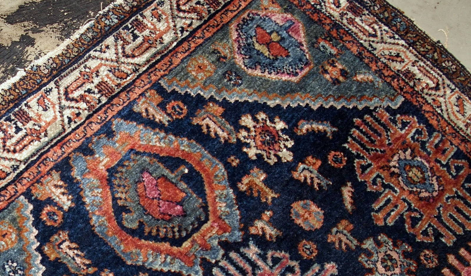 Handmade antique Malayer rug from the beginning of 20th century. The rug is in original good condition, has all-over design on navy blue background.