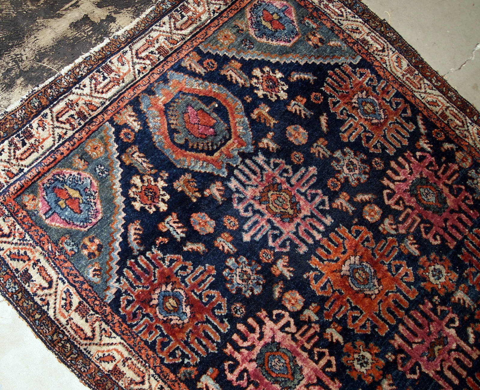 Handmade antique Malayer rug from the beginning of 20th century. The rug is in original good condition, has all-over design on navy blue background.