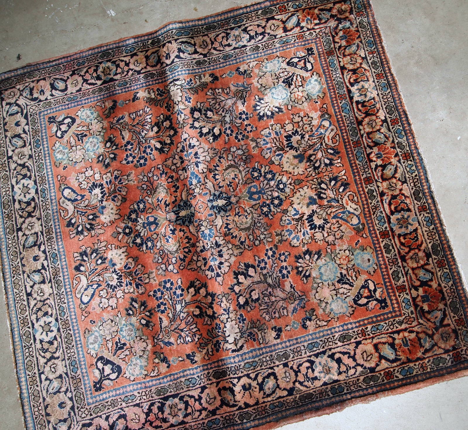 Hand-weaved antique Sarouk square rug from the beginning of 20th century. The rug is in original good condition, made in classic floral design in red and sky blue shades.