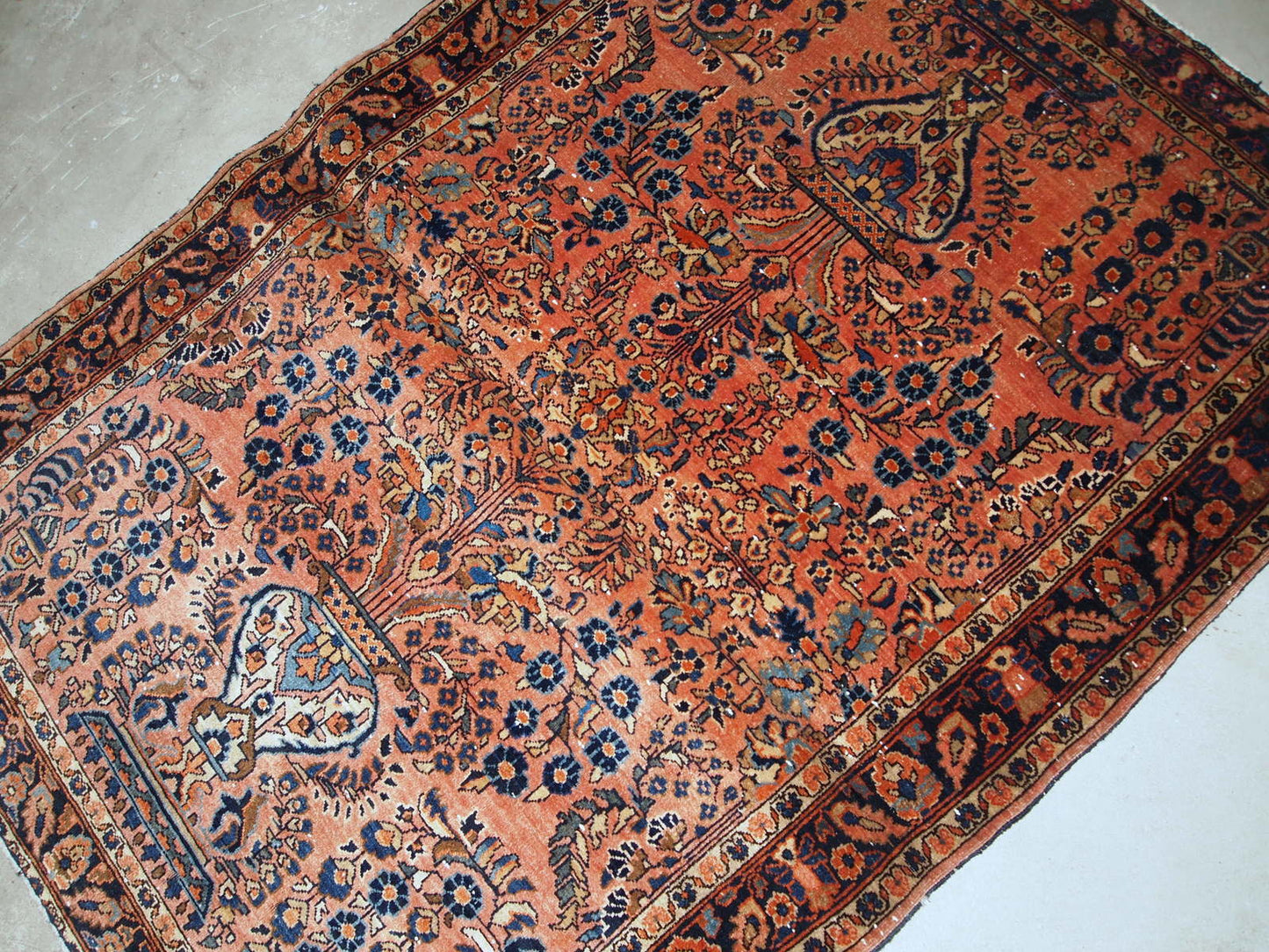 Hand-weaved antique Sarouk rug from the beginning of 20th century. The rug is in original good condition.