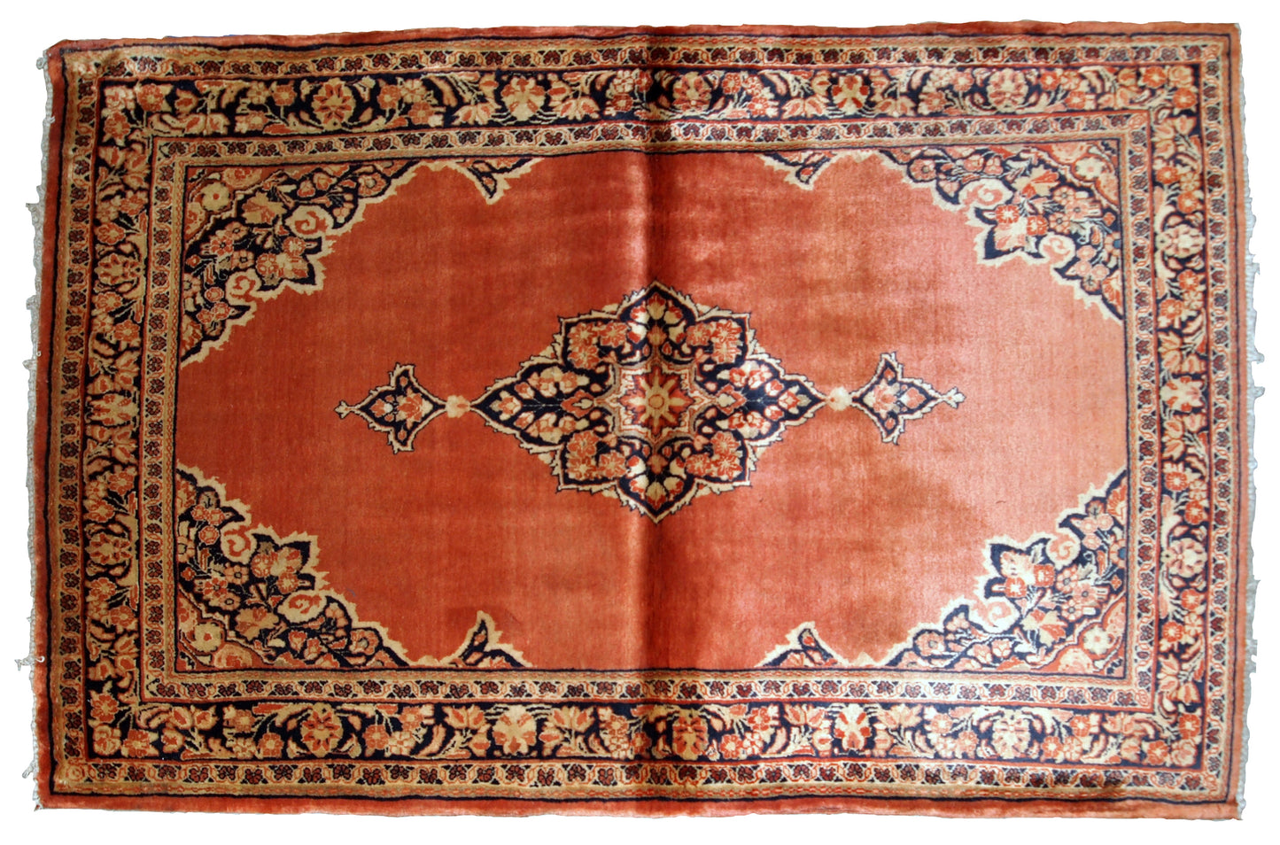 Hand-weaved antique Sarouk rug from the beginning of 20th century. The rug is in original good condition, made in traditional design from the shiny wool.
