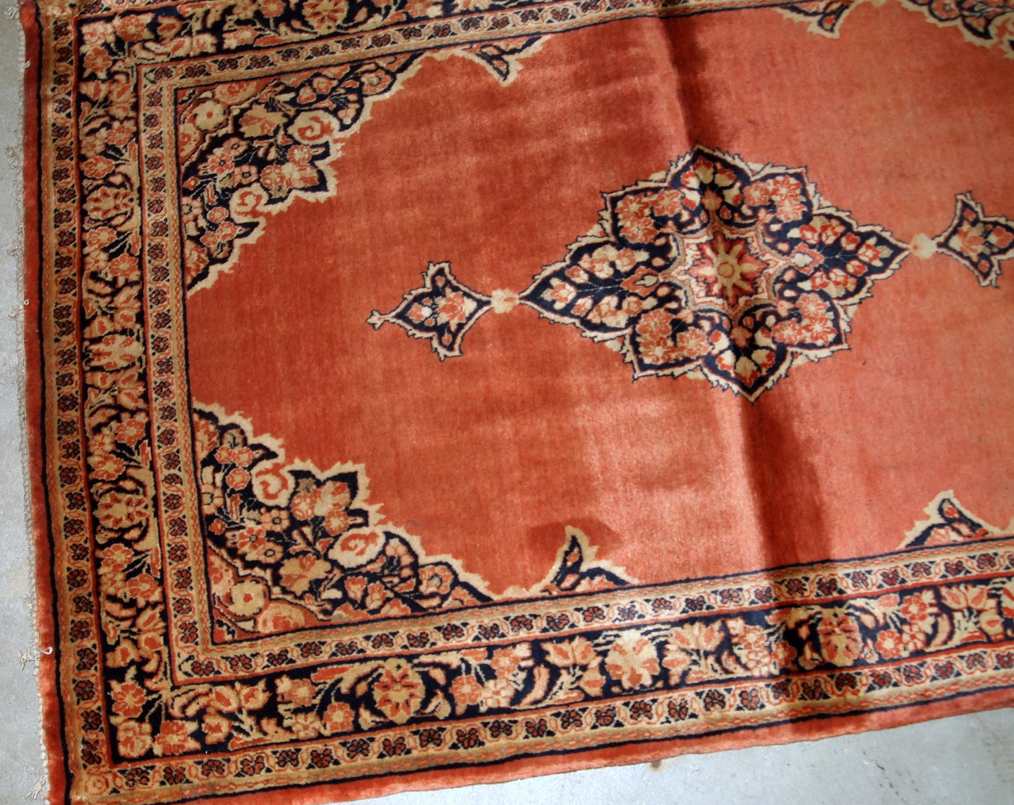 Hand-weaved antique Sarouk rug from the beginning of 20th century. The rug is in original good condition, made in traditional design from the shiny wool.