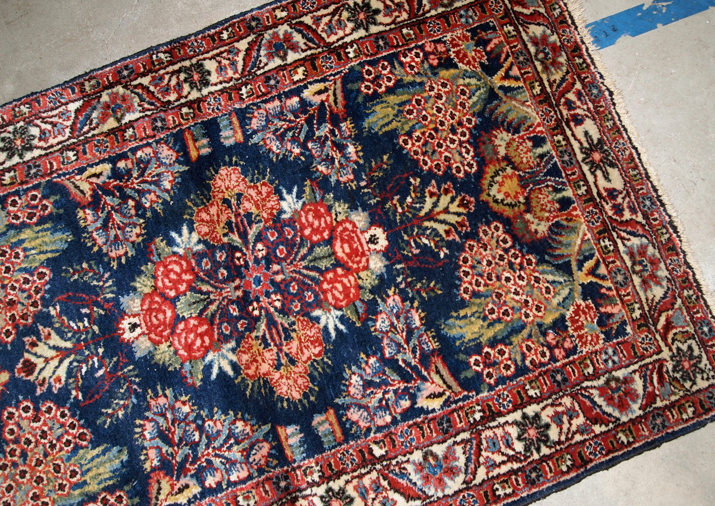 Handmade antique Hamadan rug from the beginning of 20th century. The rug is in original good condition made in bright shades and floral design.