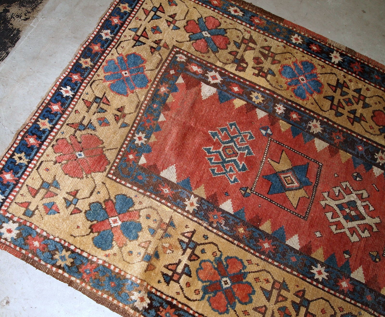 Handmade antique Caucasian Kazak rug in red and yellow shades. The rug is from the end of 19th century from Russia in original good condition.