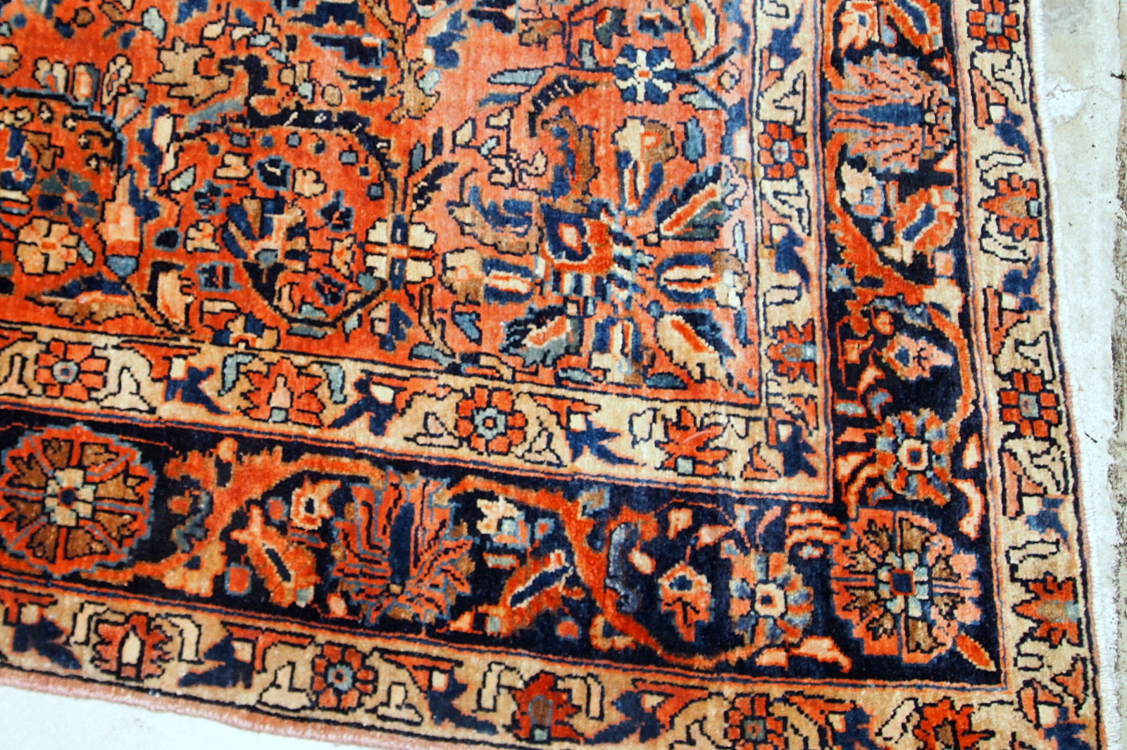 Handmade antique Sarouk rug from the beginning of 20th century. The rug is in original good condition made in red wool.