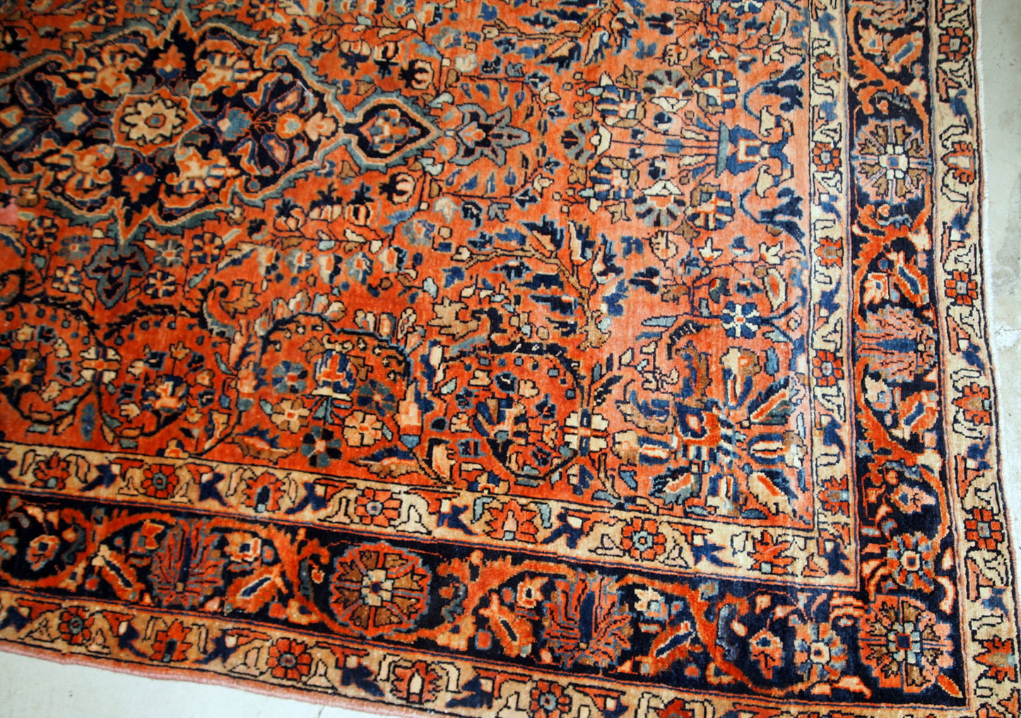Handmade antique Sarouk rug from the beginning of 20th century. The rug is in original good condition made in red wool.