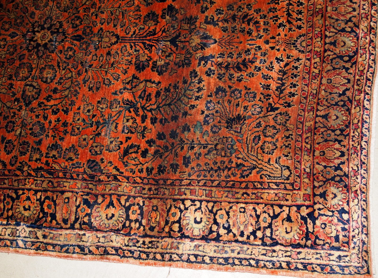Antique handmade Persian Sarouk rug in original good condition. The rug is from the beginning of 20th century made in red wool.