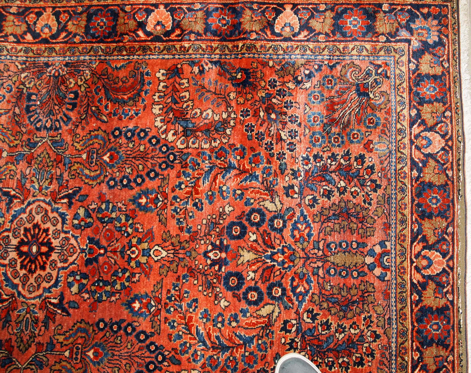 Handmade antique Sarouk rug in original good condition. The rug has been made in the beginning of 20th century in  red wool.