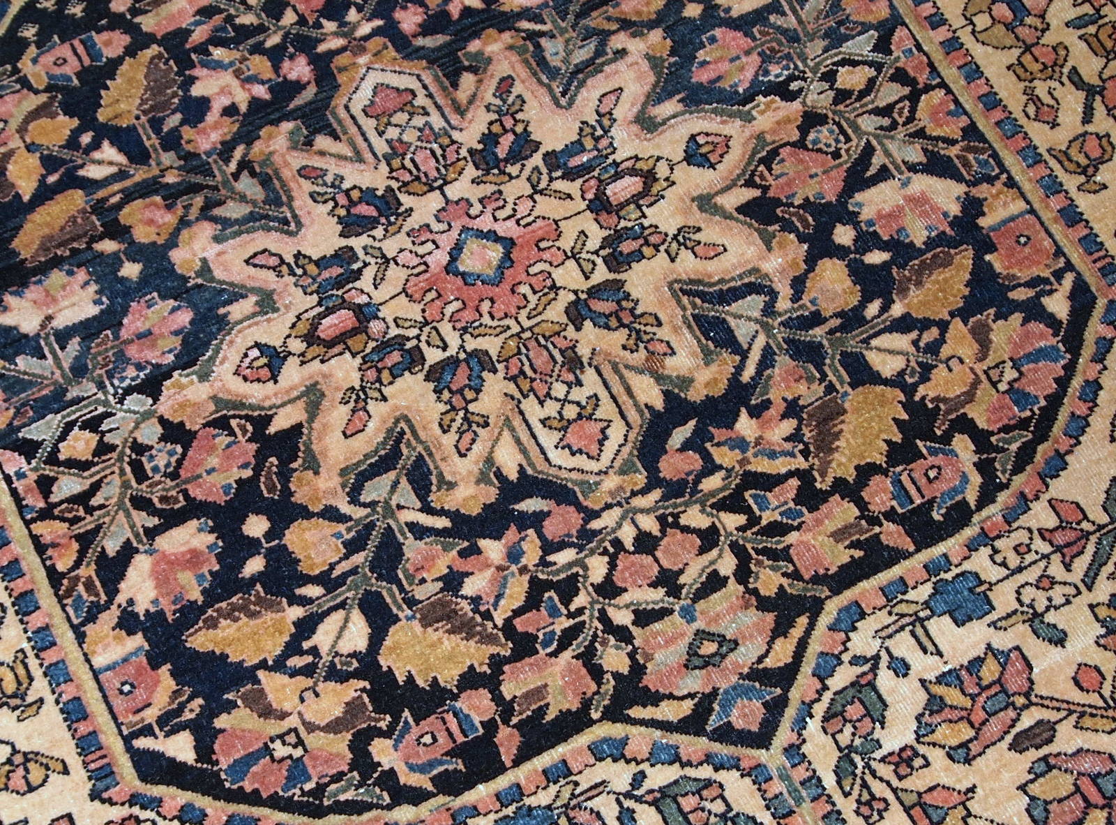 Handmade antique Sarouk Farahan rug in original good condition, has some low pile. The rug has been made in the beginning of 20th century.