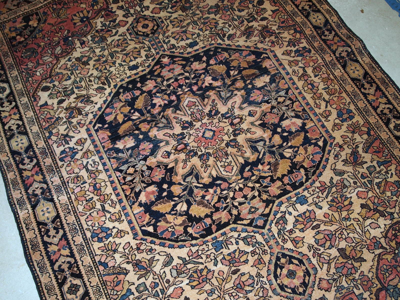 Handmade antique Sarouk Farahan rug in original good condition, has some low pile. The rug has been made in the beginning of 20th century.