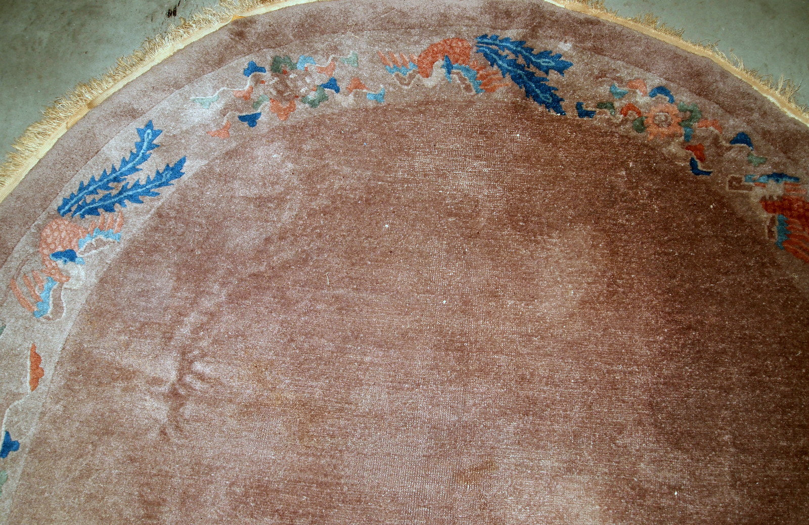 Handmade antique Art Deco Chinese rug in oval shape. The rug is from the beginning of 20th century in original condition, it has some low pile.