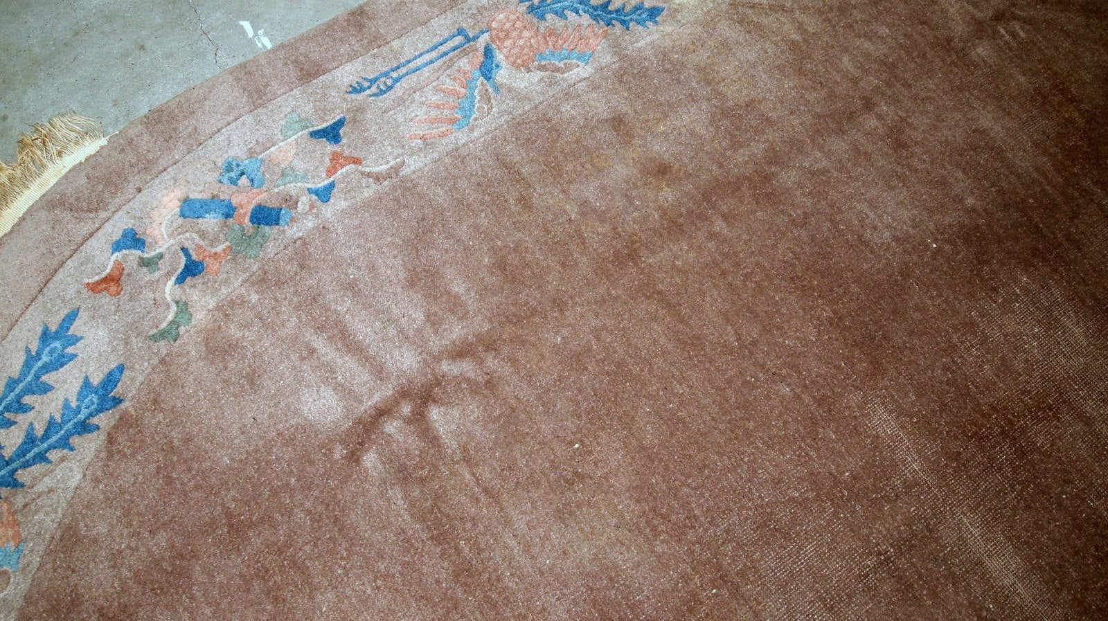 Handmade antique Art Deco Chinese rug in oval shape. The rug is from the beginning of 20th century in original condition, it has some low pile.