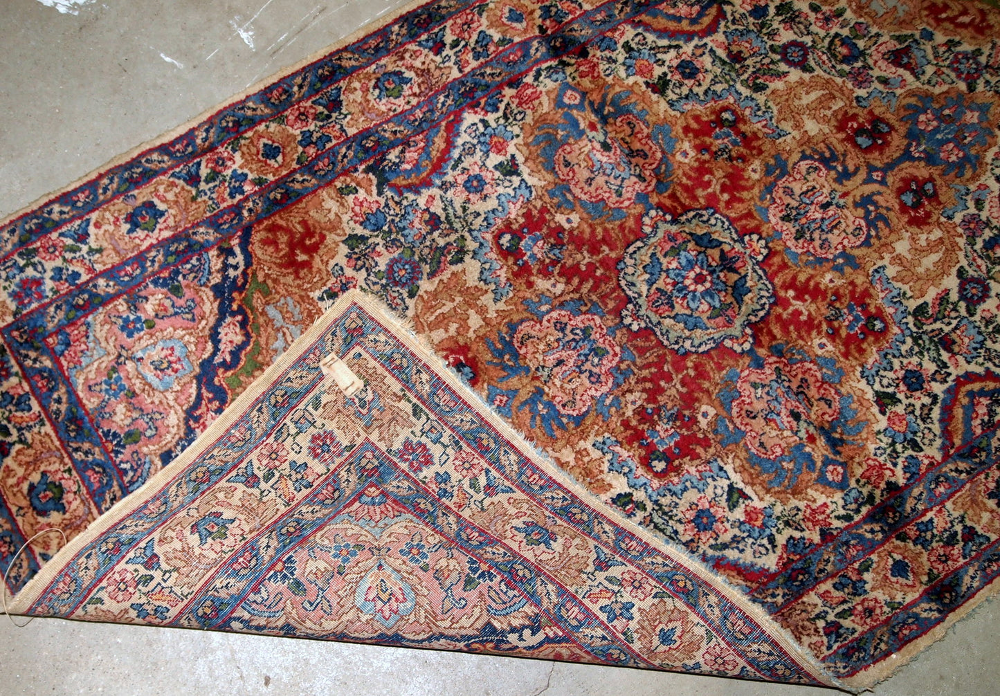 Handmade antique Kerman rug from Middle East in colorful shades. The rug is in original good condition.