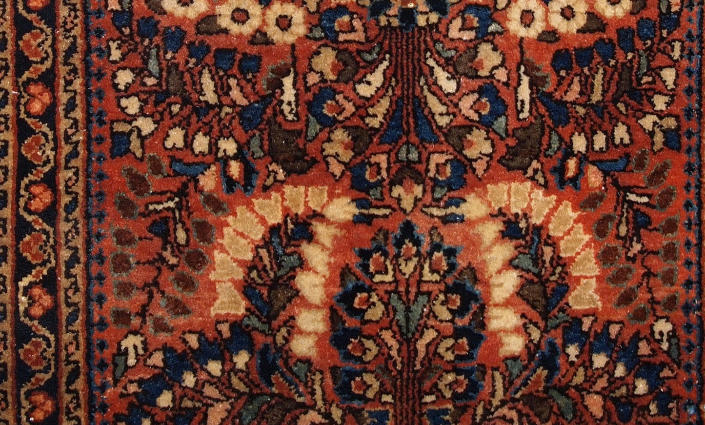 Handmade antique Persian Sarouk rug in original good condition. The rug is from the beginning of 20th century made in traditional design.