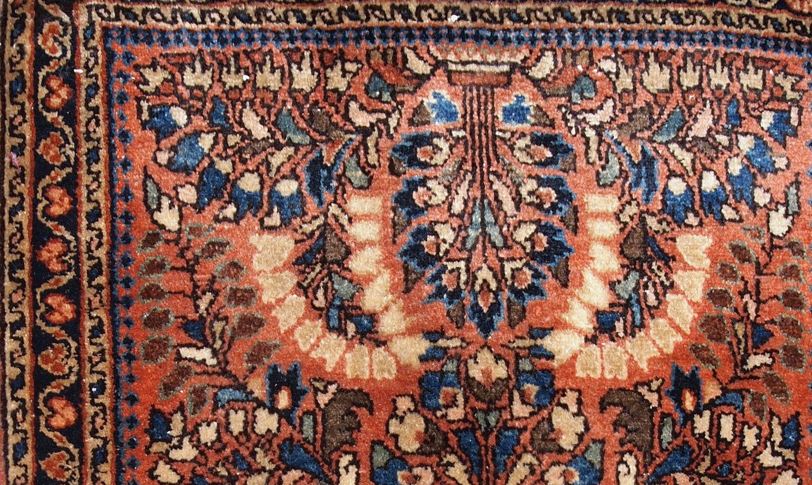 Handmade antique Persian Sarouk rug in original good condition. The rug is from the beginning of 20th century made in traditional design.
