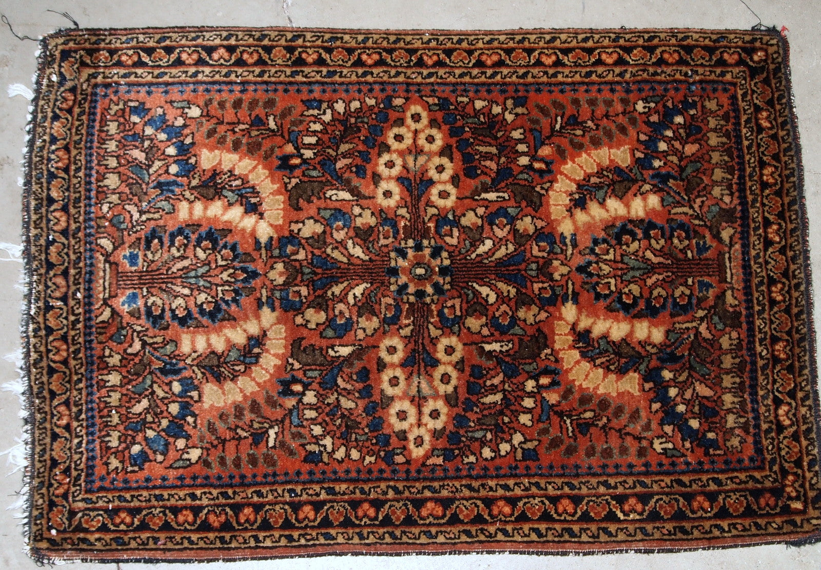 Handmade antique Persian Sarouk rug in original good condition. The rug is from the beginning of 20th century made in traditional design.