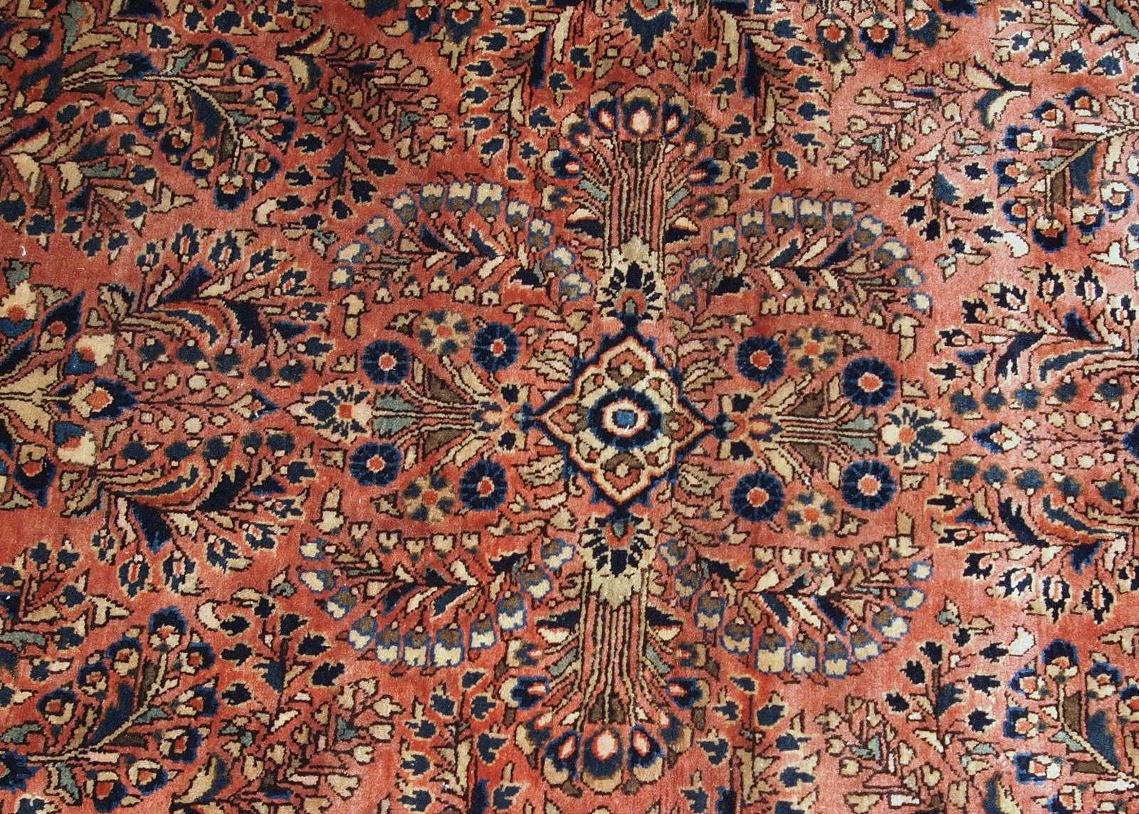 Handmade antique Persian Sarouk rug in original good condition. The rug is from the beginning of 20th century made in traditional design.