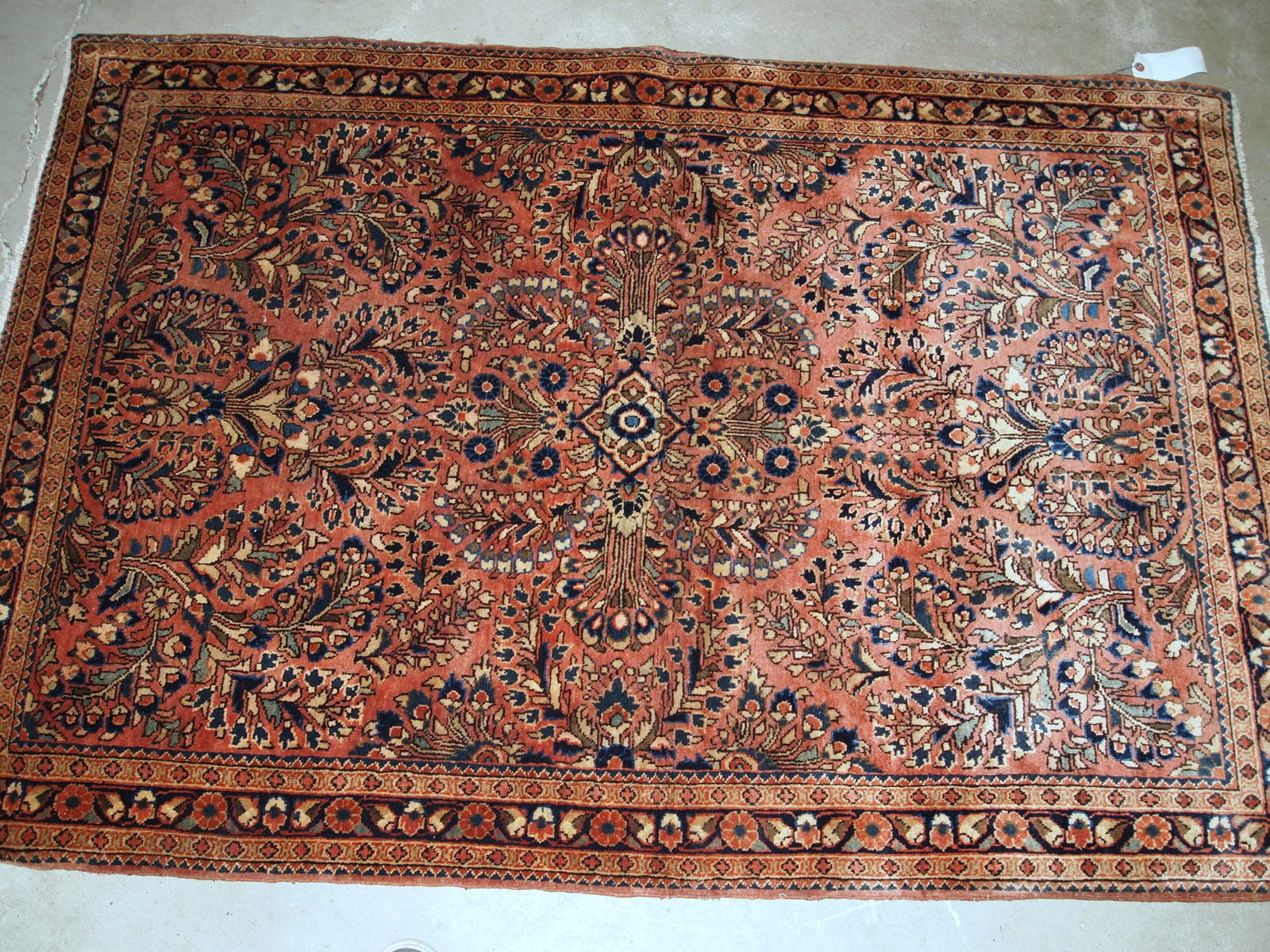 Handmade antique Persian Sarouk rug in original good condition. The rug is from the beginning of 20th century made in traditional design.