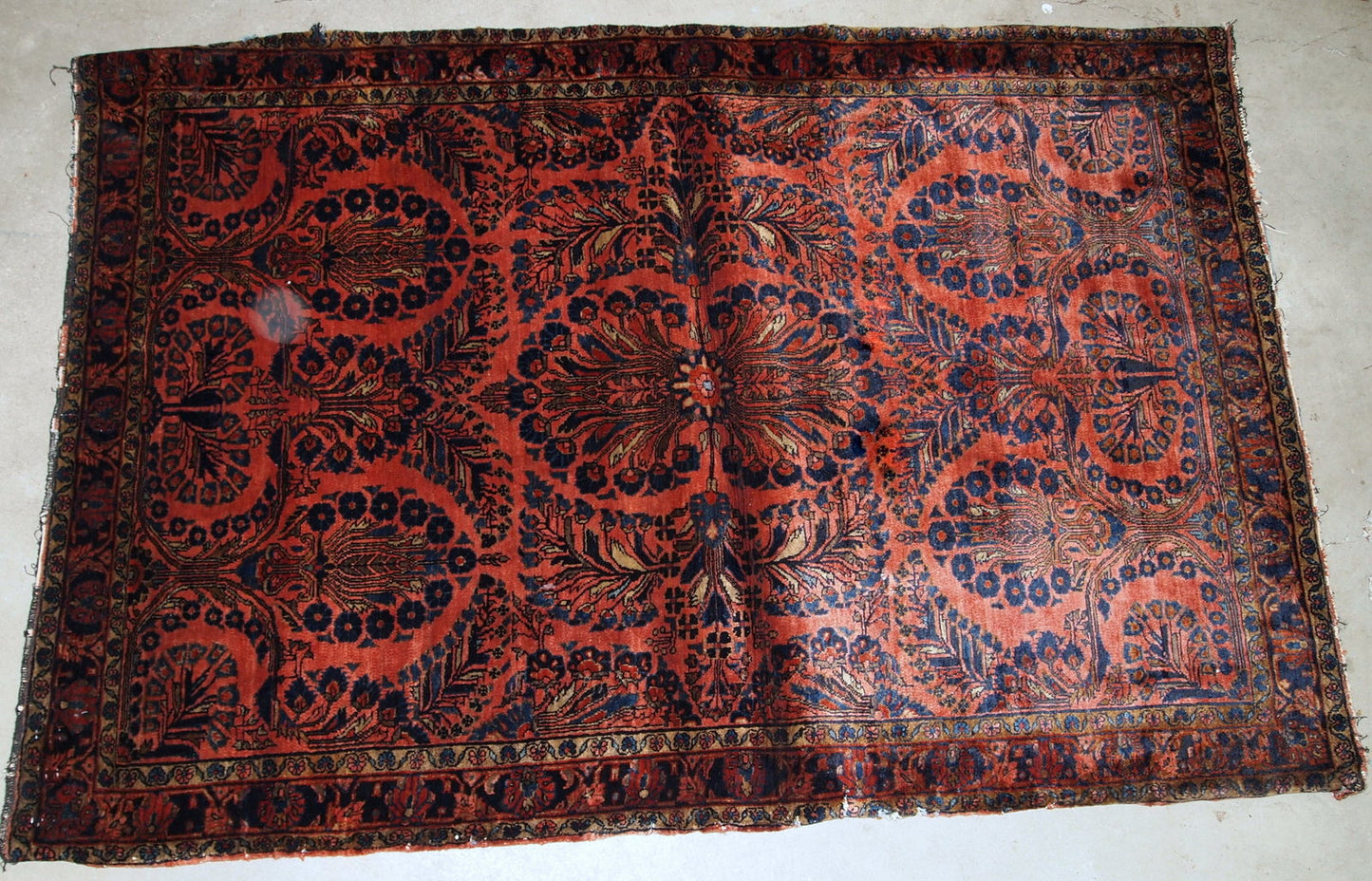 Handmade antique Persian Sarouk rug in original good condition. The rug is from the beginning of 20th century made in bright red shade.