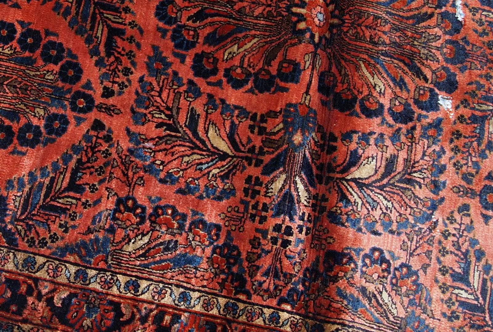 Handmade antique Persian Sarouk rug in original good condition. The rug is from the beginning of 20th century made in bright red shade.