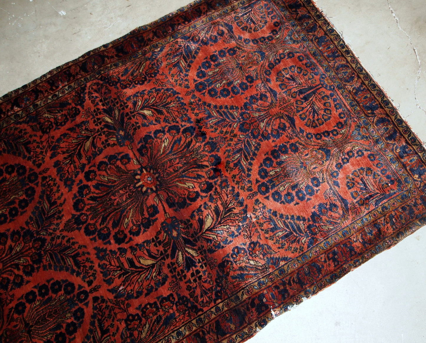 Handmade antique Persian Sarouk rug in original good condition. The rug is from the beginning of 20th century made in bright red shade.