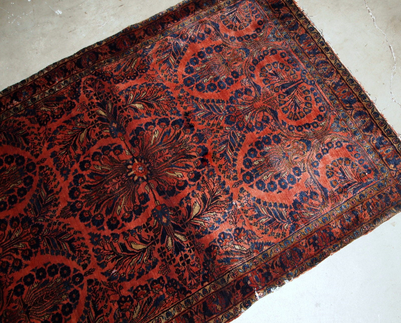 Handmade antique Persian Sarouk rug in original good condition. The rug is from the beginning of 20th century made in bright red shade.