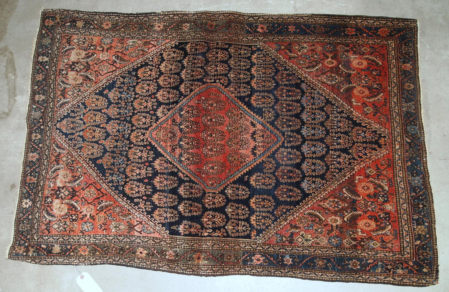 Handmade antique Persian Farahan rug in original good condition. The rug is from the beginning of 20th century made in floral and geometric designs.