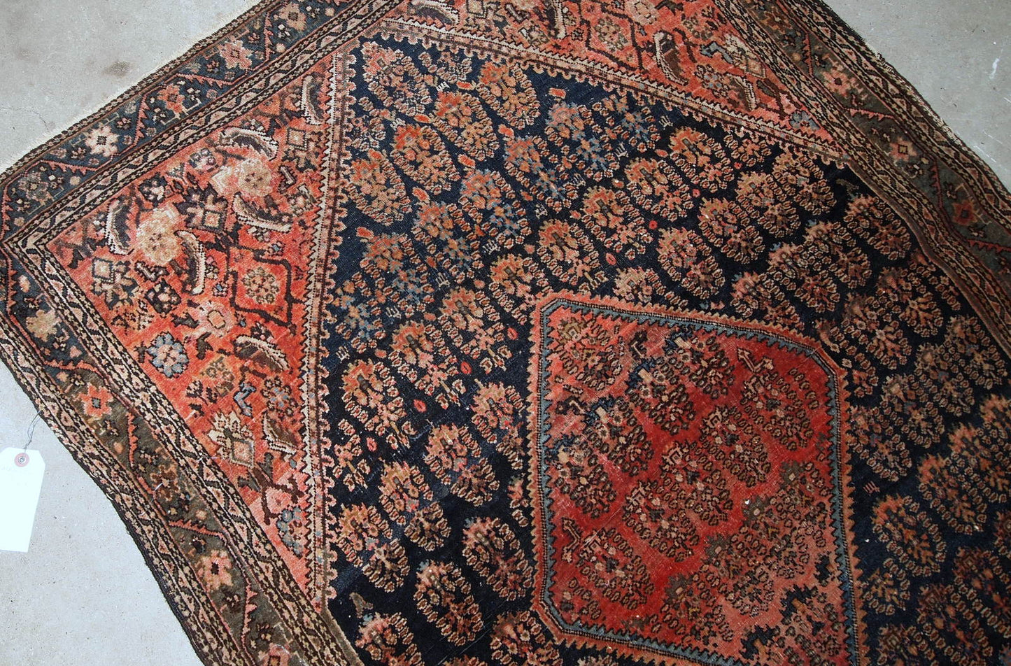 Handmade antique Persian Farahan rug in original good condition. The rug is from the beginning of 20th century made in floral and geometric designs.