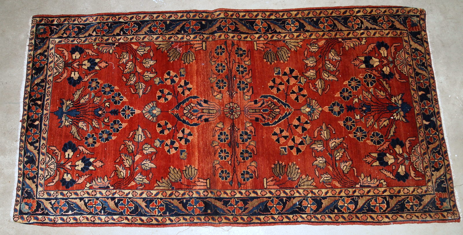 Handmade antique Persian Sarouk Mahajeran rug in original good condition. The rug is from the beginning of 20th century made in bright red wool.