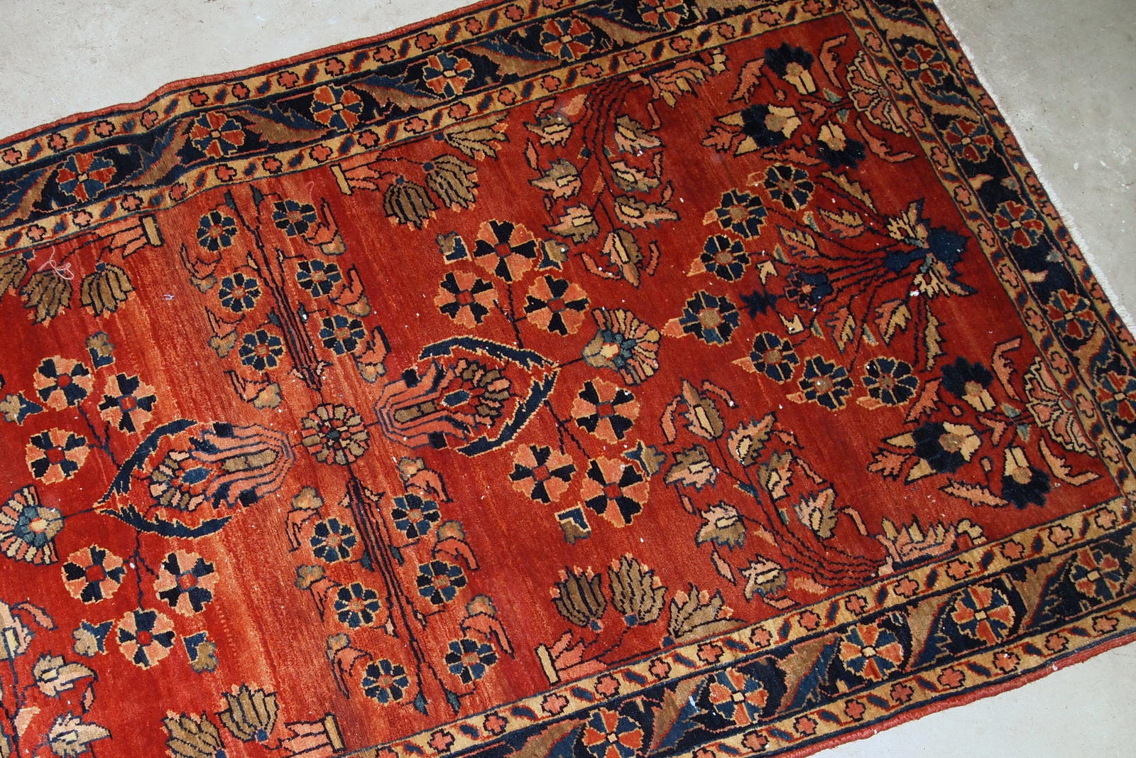 Handmade antique Persian Sarouk Mahajeran rug in original good condition. The rug is from the beginning of 20th century made in bright red wool.